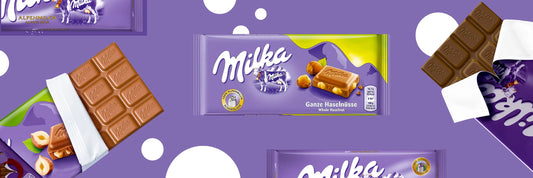 Milka chocolate bars, including unwrapped pieces, are displayed on a purple background with white circles. Hazelnuts and branding are visible on the main packaging.