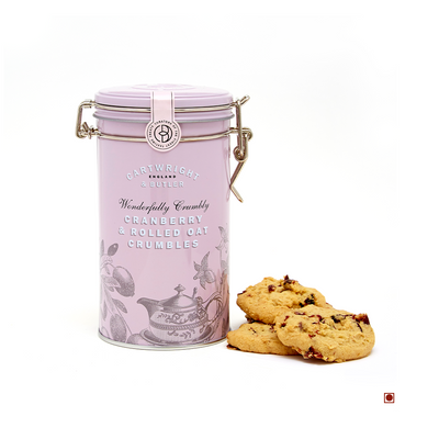 A Cartwright & Butler Cranberry & Rolled Oats Crumbles Tin 200g next to a tin of raisin cookies with chewy texture.