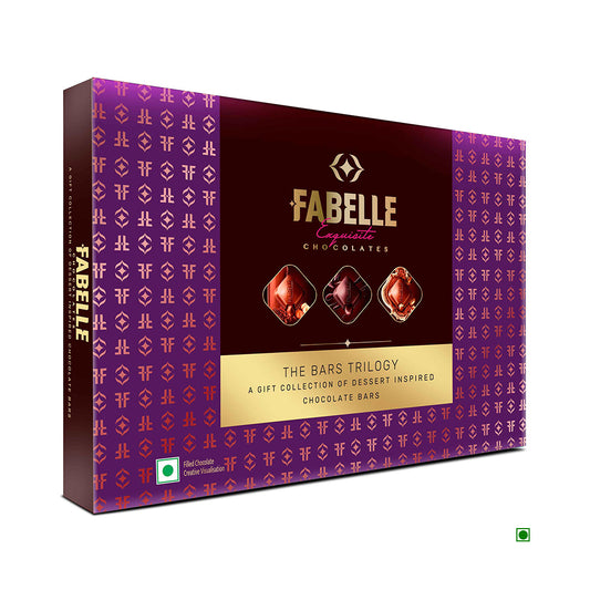 A purple box of Fabelle The Bars Trilogy With Tiramisu 386g from India displays images of three chocolate bars and a green logo.