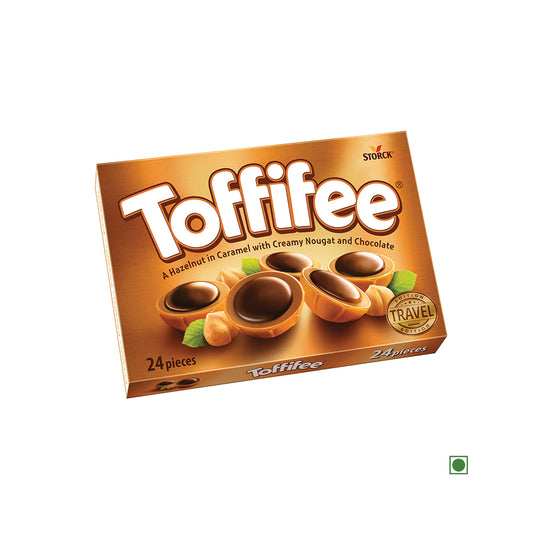 A box of Toffifee Hazelnut In Caramel With Creamy Nougat And Chocolate 200g containing 24 delectable caramel cups. The brown packaging showcases images of these candies, each featuring a hazelnut in caramel with creamy nougat and luscious chocolate.