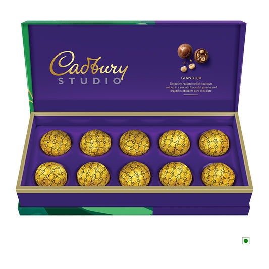 A box containing 10 Cadbury Gianduja 130g pralines, elegantly wrapped in gold and presented in a stylish purple box with an open lid. Crafted with care and precision, these exquisite treats proudly originate from India.