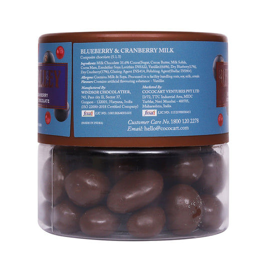 A jar of Rhine Valley's Rhine Valley Blueberry & Cranberry Milk Dragees 100g, with ingredients and contact info on the label.