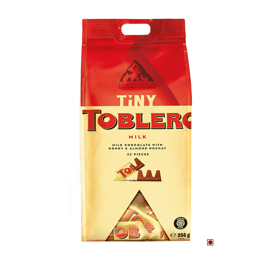 A travel exclusive package of Toblerone Tiny Milk Bag 256g, displaying 32 pieces, and a weight indication of 256 grams.