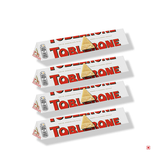 A staggered formation of four Toblerone White Chocolate bars (100g each, total 400g) is set against a white backdrop, highlighting the famous Swiss chocolate's honey and almond nougat flavors.