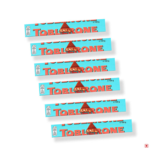 Six Toblerone Milk Chocolate with Crunchy Almonds bars (600g) are arranged diagonally in a row on a white background.
