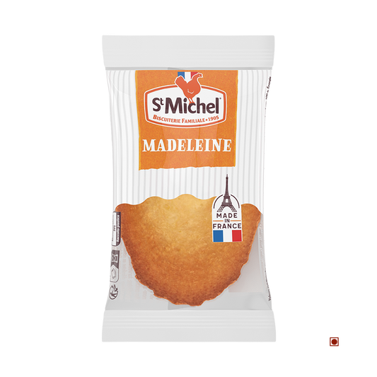 A St. Michel Madeleine 25g pastry, branded "St. Michel" and labeled "Made in France," is displayed against a white background.