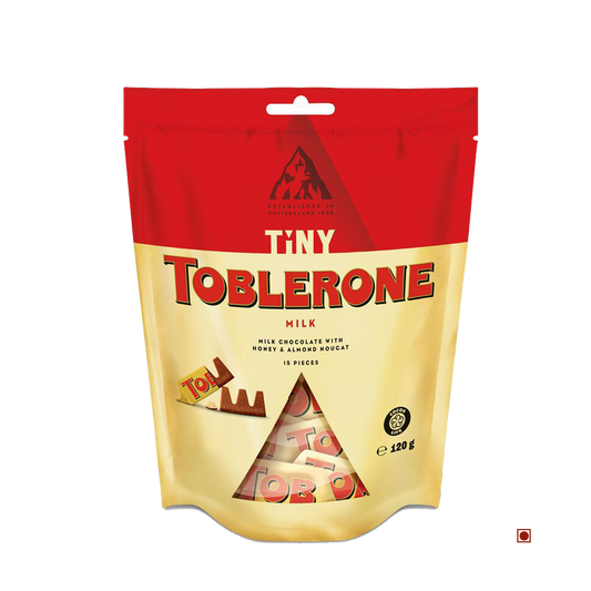 Toblerone Tiny Milk Bag 120G by Cococart India contains individually wrapped Swiss milk chocolate pieces with honey almond nougat.