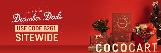 A holiday-themed advertisement for COCOKART offering "December Deals" with the promo code "B2G1" for sitewide use. The image includes gift boxes, a small Christmas tree, and red background.