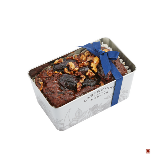A Cartwright & Butler Date & Walnut Decorated Loaf Cake Tin 550g with a blue ribbon, perfect for nut lovers.