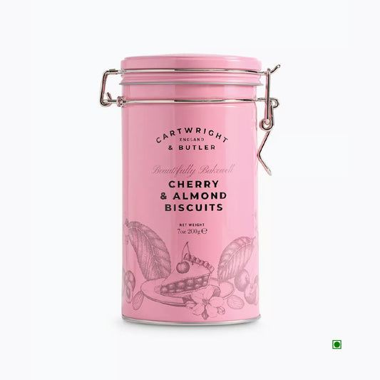 The pink cylindrical tin, labeled "Cartwright & Butler Cherry & Almond Biscuits Tin 200g," features charming illustrations of cherries, almonds, and buttery biscuits.