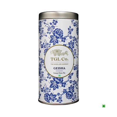 Decorative tea tin by Cococart India labeled "TGL Co. Geisha Luxury Green Tea 35g," featuring a blue floral pattern and gold accents.