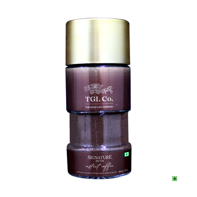 A brown and gold coffee container labeled "Cococart India TGL Co. Signature Filter Instant Coffee 100g" with a green quality assurance sticker.