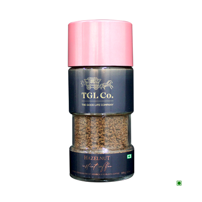 A sealed transparent container of Cococart India Hazelnut Instant Coffee 100g with a pink cap, isolated on a white background.