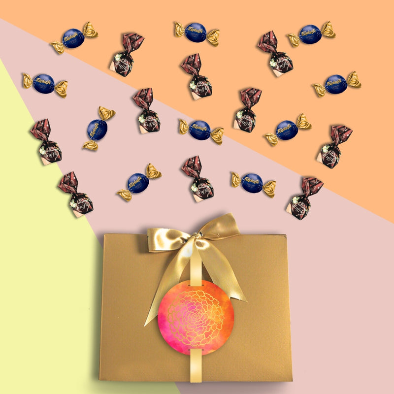 A Gift Hampers filled with Bribe in a Box - Raksha Bandhan Collection chocolates and candies.