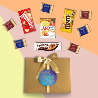 A "The Always Right Sibling - Raksha Bandhan Collection" gift box featuring a variety of sweets and chocolates by Gift Hampers.