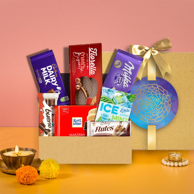 A chocolate hamper filled with delectable chocolates and a scented candle, The Azure Festive Opulence by Gift Hampers, available for delivery.