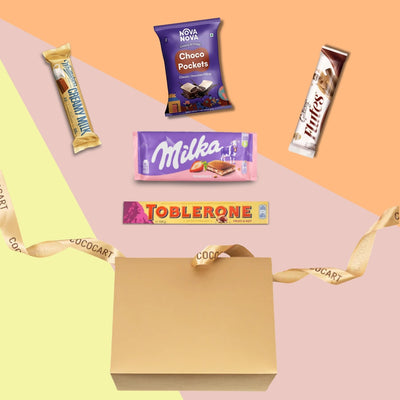A Season's Greetings Giftbox filled with a variety of candy bars and adorned with a ribbon.