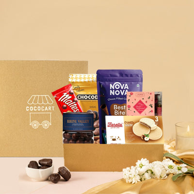 A Happy Moments Giftbox filled with delightful chocolates, scrumptious cookies, and a vibrant assortment of flowers, perfect for celebrating the New Year or any lively party.