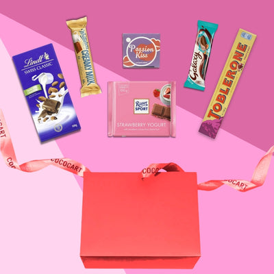 Valentine's day gift box with chocolates and a ribbon, also known as Cupid's Care Package: Valentine's Day Edition by Gift Hampers, available in India.