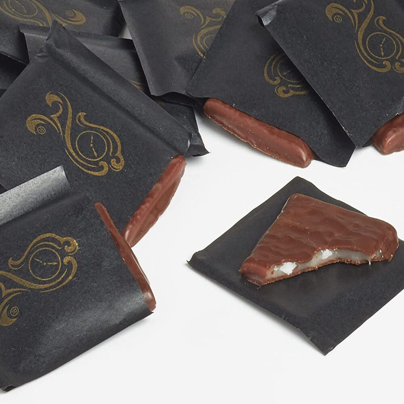 A group of After Eight Mint Chocolate Thins Boxes 200g in black bags on a white surface.