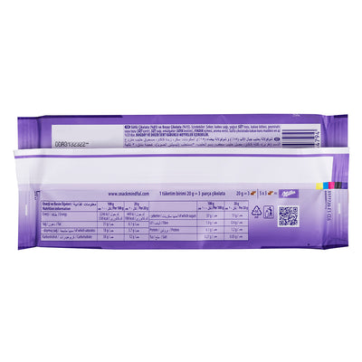 A bag with a purple Milka Cowspot Bar 100g label on a white background with cow spots.