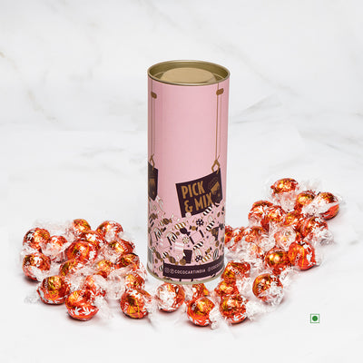 A tin of Pick & Mix : Lindor Milk 100/250/500g chocolates sitting on top of a marble table. (Brand Name: Lindt)
