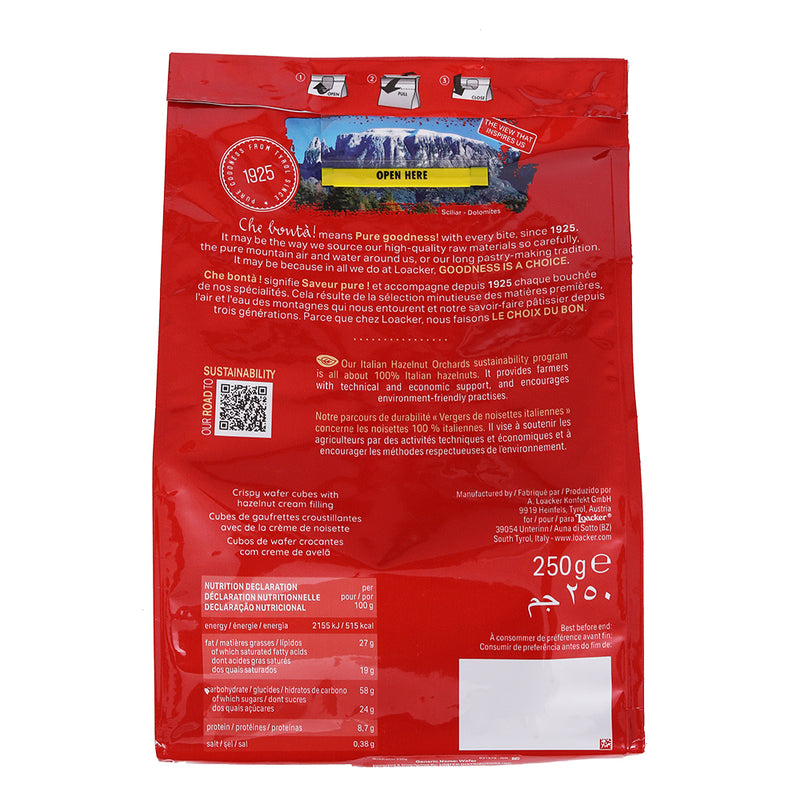 A red Loacker coffee bag featuring English and French text, a QR code, nutritional information, and an image of a rural Italian landscape at the top.