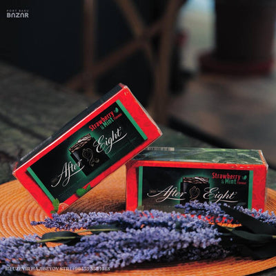Two boxes of After Eight Strawberry Mint Chocolate Thins 200g sitting on top of a table.