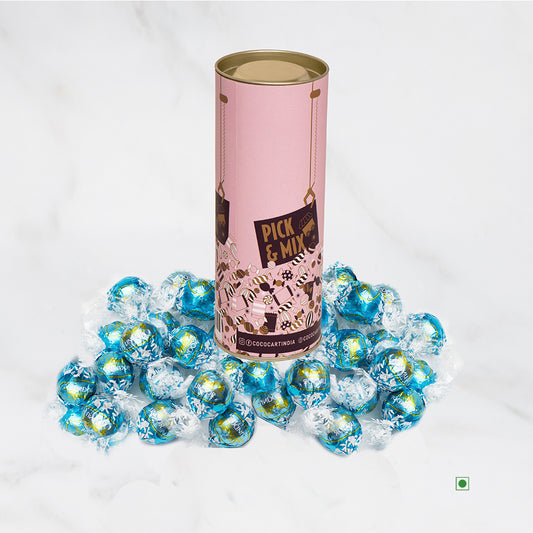 A Lindt tin filled with pink and blue candies.