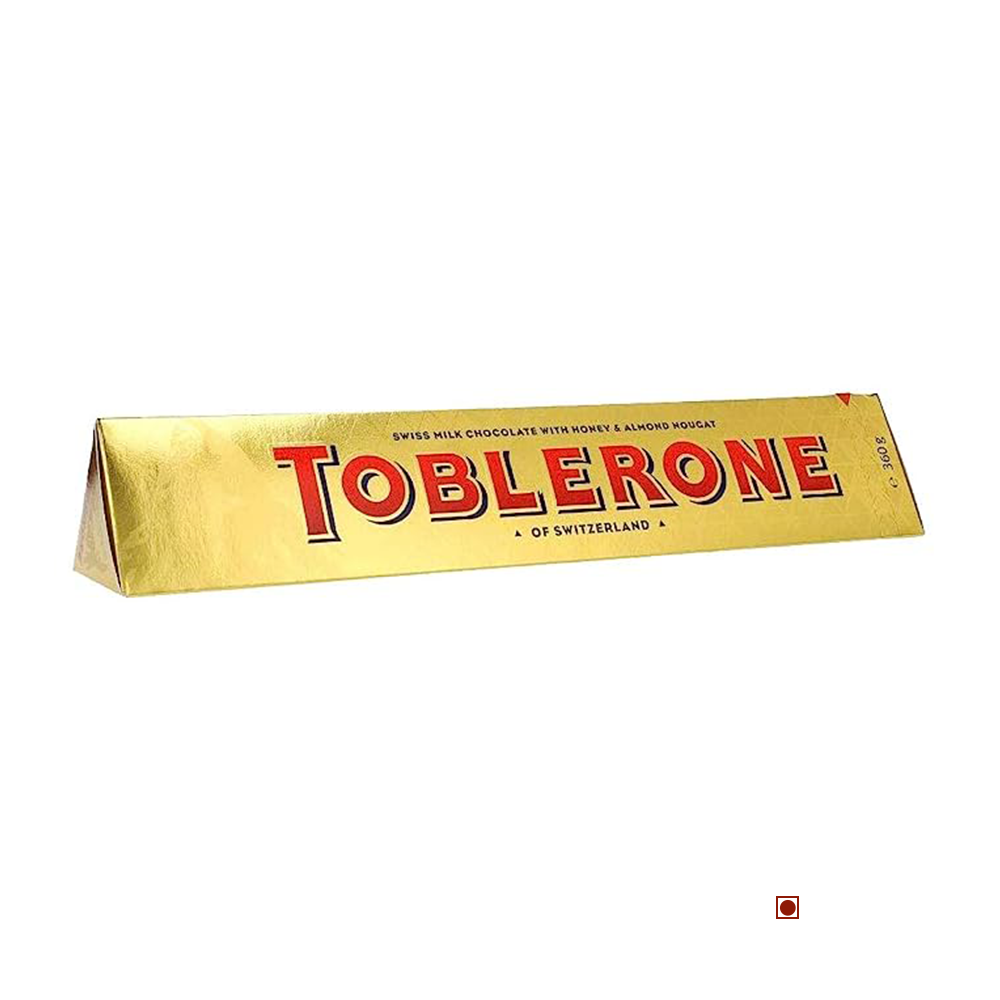 The Toblerone Gold 360g chocolate bar packaging showcases the text "Swiss Milk Chocolate with Honey & Almond Nougat" and "of Switzerland," embodying a taste that truly represents the best of Swiss confectionery.