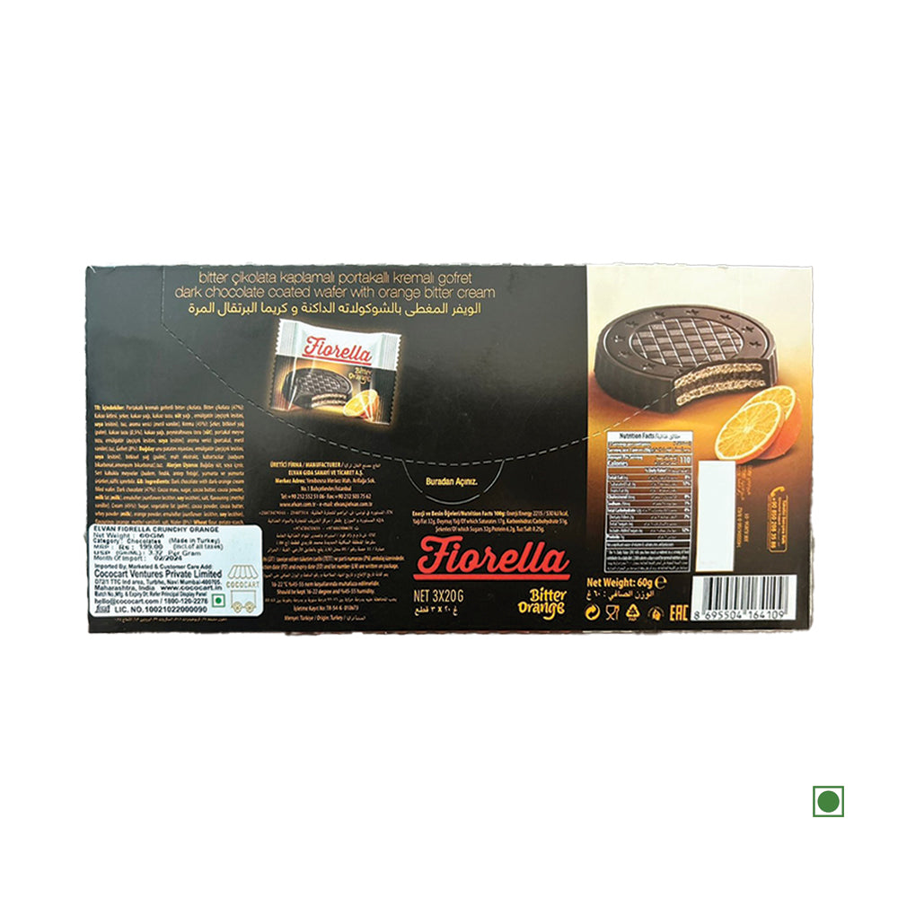 A box of Elvan Fiorella Crunchy Orange Cream with Chocolate Wafer 60g, coated in rich chocolate and filled with a tangy orange cream, displays product details and an image featuring the delectable wafers beside a fresh orange slice.