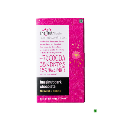 A bar of The Whole Truth Hazelnut Dark Chocolate 90g with a pink background.