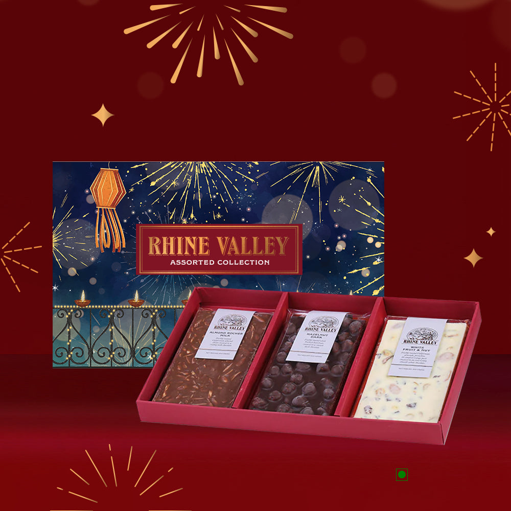 A 300g box of Rhine Valley Milk, Dark & White Assorted Collection, featuring three exquisite flavors, is beautifully displayed against a festive background with fireworks.