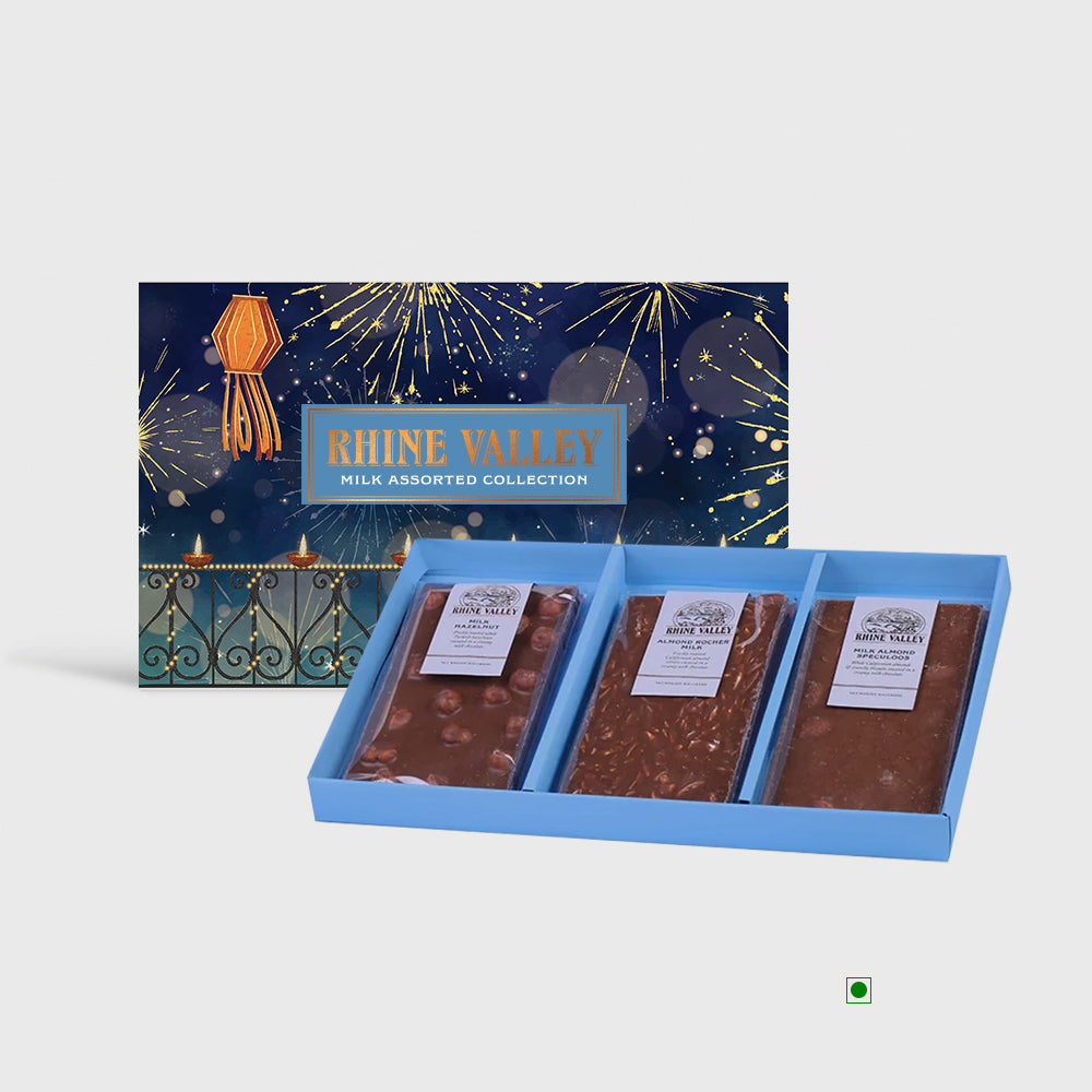 Introducing the Rhine Valley Milk Assorted Collection 300g: a delectable array of milk chocolates elegantly presented in a stylish blue tray. The packaging comes alive with vibrant fireworks and lanterns, setting a magical stage for this exquisite gift box by Rhine Valley.