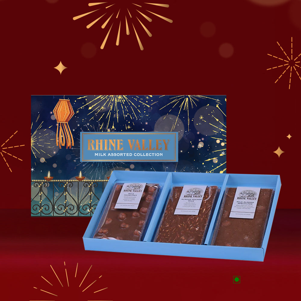 The Rhine Valley Milk Assorted Collection 300g by Rhine Valley offers a gourmet selection of chocolates. The assortment is beautifully packaged with three bars set against a festive red background adorned with fireworks graphics.