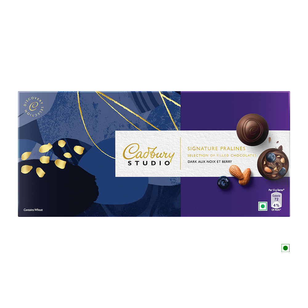 Cadbury Assortment Box 234g, containing 18 pralines, features assorted filled chocolates with an artistic design on the left and a blueberry and nut illustration on the right. Proudly crafted in India, these exquisite treats from Cadbury offer a taste of luxury and indulgence.