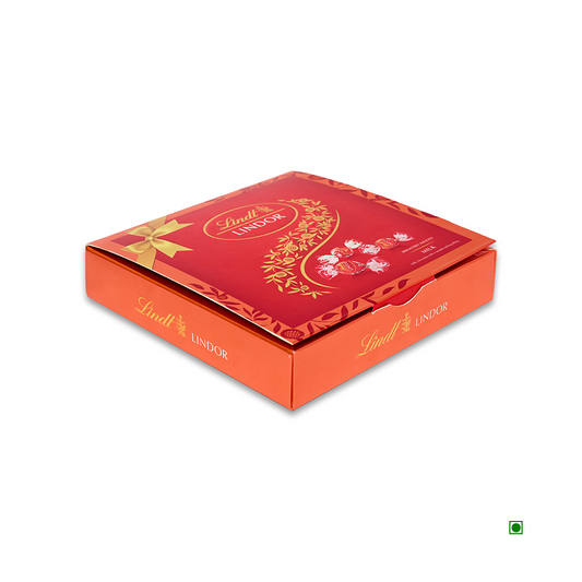 The Lindt Lindor Milk Box 100g, featuring a sophisticated design with gold accents and a prominent green symbol in the bottom right corner, captures the luxurious Swiss chocolatier tradition.