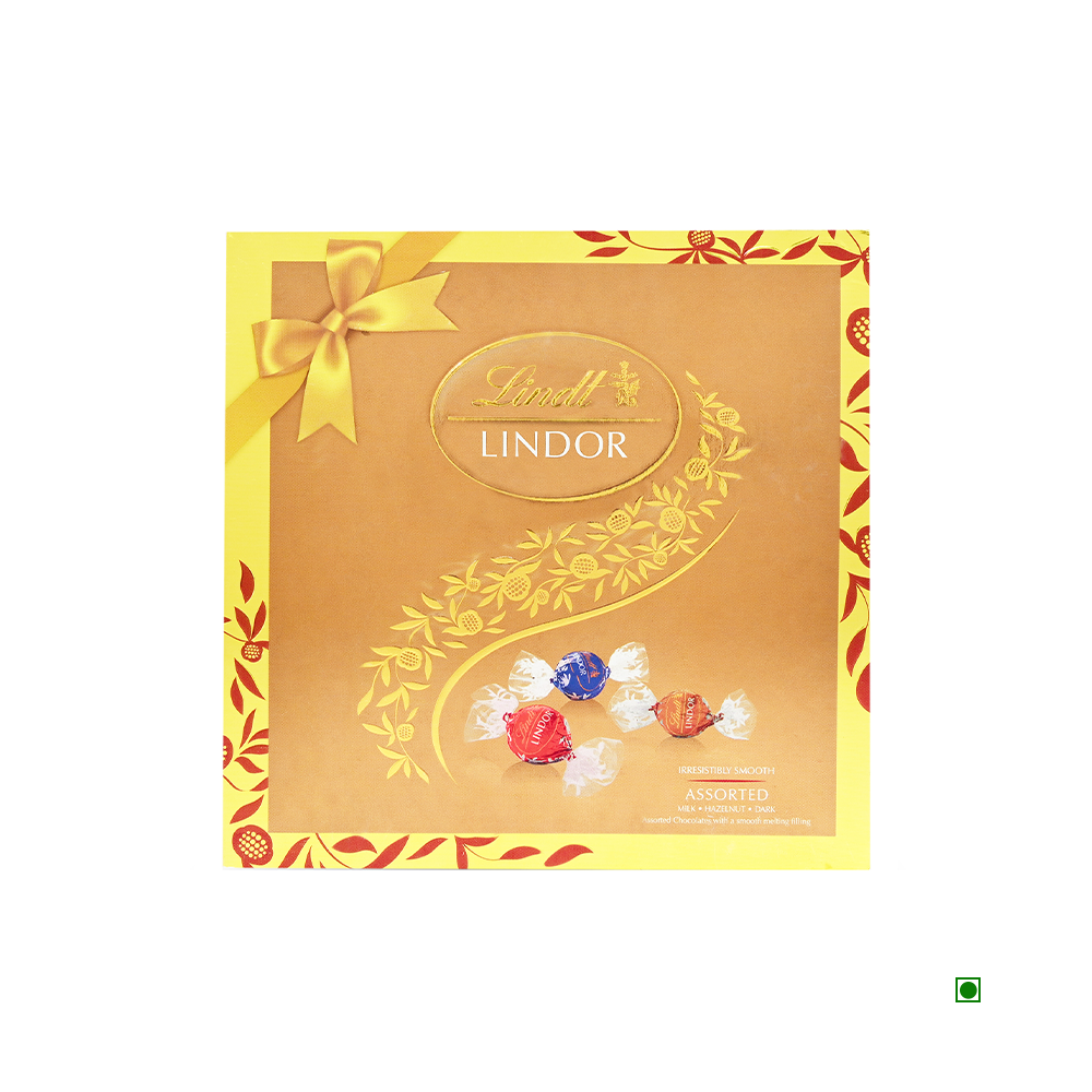 A 100g box of Lindt Lindor Assorted Milk chocolates, made in Switzerland, is beautifully displayed on a decorative gold background adorned with a ribbon pattern.