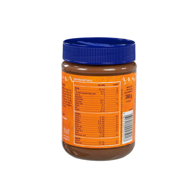 A jar of Ovomaltine Spread Crunchy Cream with a blue lid, showing the nutritional facts label on the back.