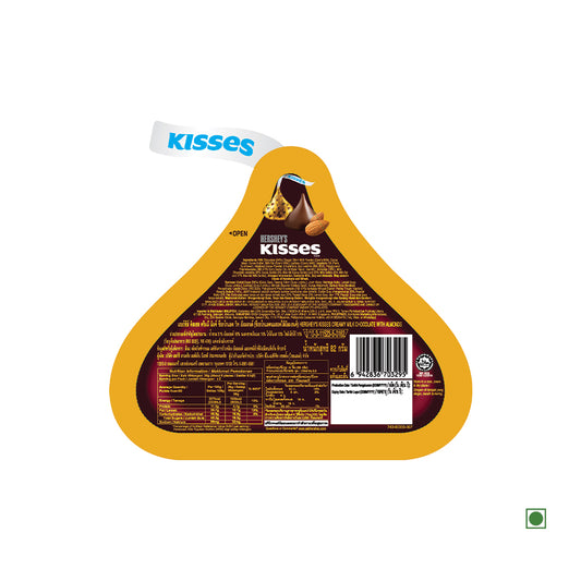 The packaging of Hershey's Kisses with Almonds Pouch 82g features instructions, ingredients, nutritional information, and a "Kisses" tab at the top. Made with rich cream milk chocolate, it includes a green dot in the bottom right corner indicating it's a vegetarian product.