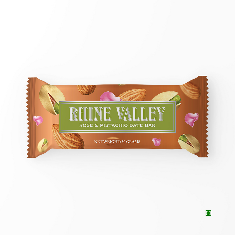A Rhine Valley Rose & Pistachio Date Bar 50g with almonds, pistachios, and rose petals on it.