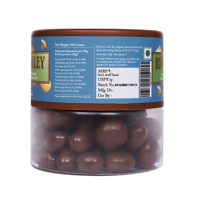Clear plastic jar of Rhine Valley Macadamia & Pistachio Milk Dragees 100g with nutritional information and barcode on the label.