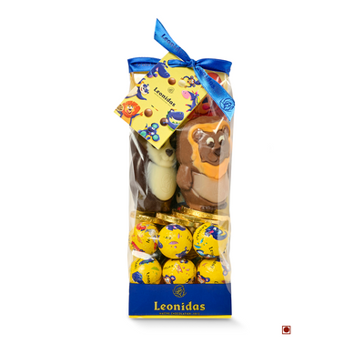 Clear gift bag filled with assorted Leonidas Kids Panorama Bag 250g chocolate balls, decorated with a blue ribbon and featuring a visible chocolate figure resembling an animal.