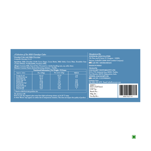 The reverse side of the Rhine Valley Gianduja Cubes Milk (6 Pcs) 72g chocolate box showcases its blue packaging adorned with nutritional information, ingredients, and contact details for "Windsor Chocolatier" and "Cocoacraft Ventures Pvt Ltd." Proudly made in India, the packaging prominently features the country of origin along with these key details.