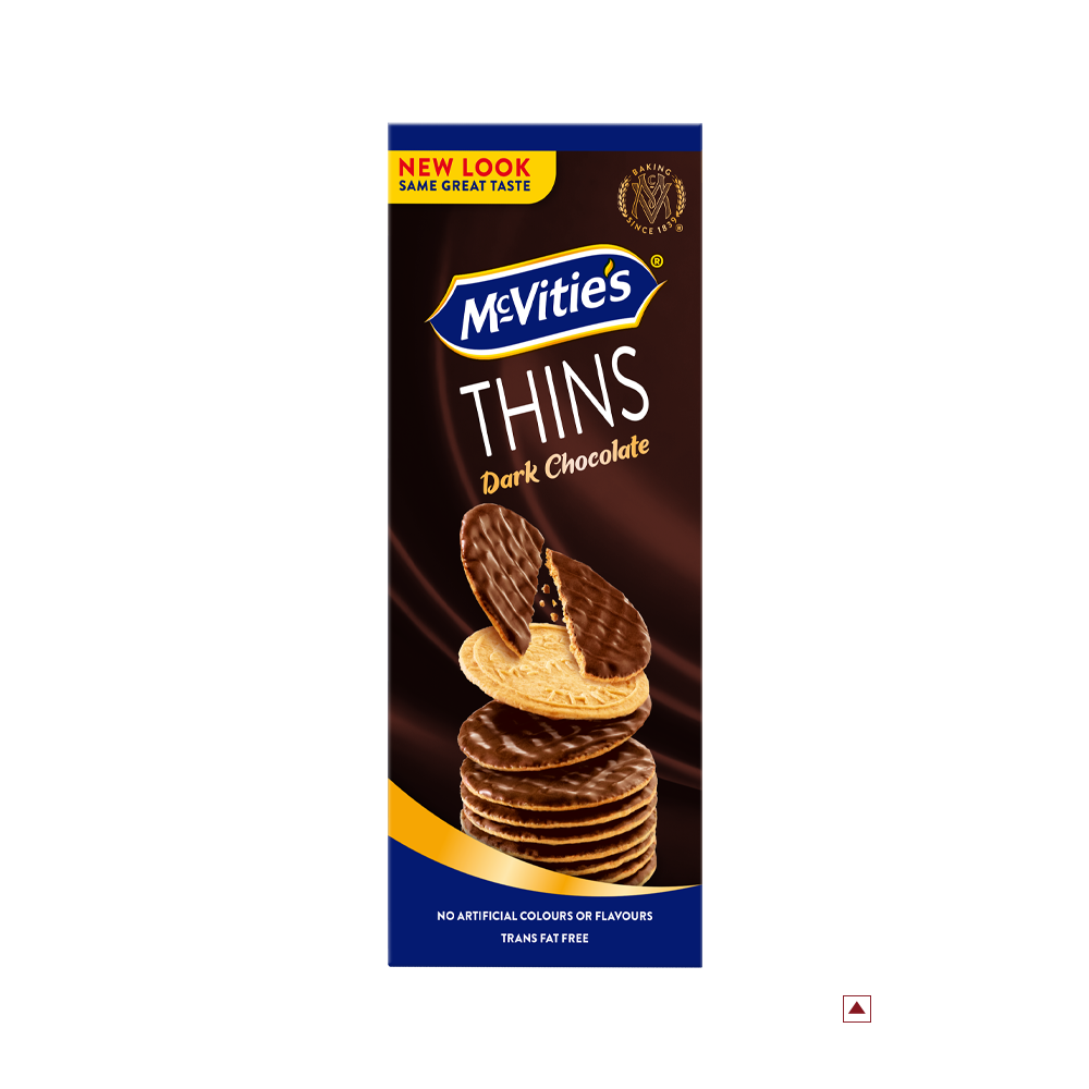 A rectangular box of McVitie’s Thins Dark Chocolate 150g biscuits is shown. The packaging highlights "New Look Same Great Taste" and states "No Artificial Colours or Flavours," and "Trans Fat Free." The label indicates the country of origin as Egypt.