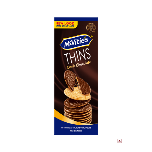 A rectangular box of McVitie’s Thins Dark Chocolate 150g biscuits is shown. The packaging highlights "New Look Same Great Taste" and states "No Artificial Colours or Flavours," and "Trans Fat Free." The label indicates the country of origin as Egypt.