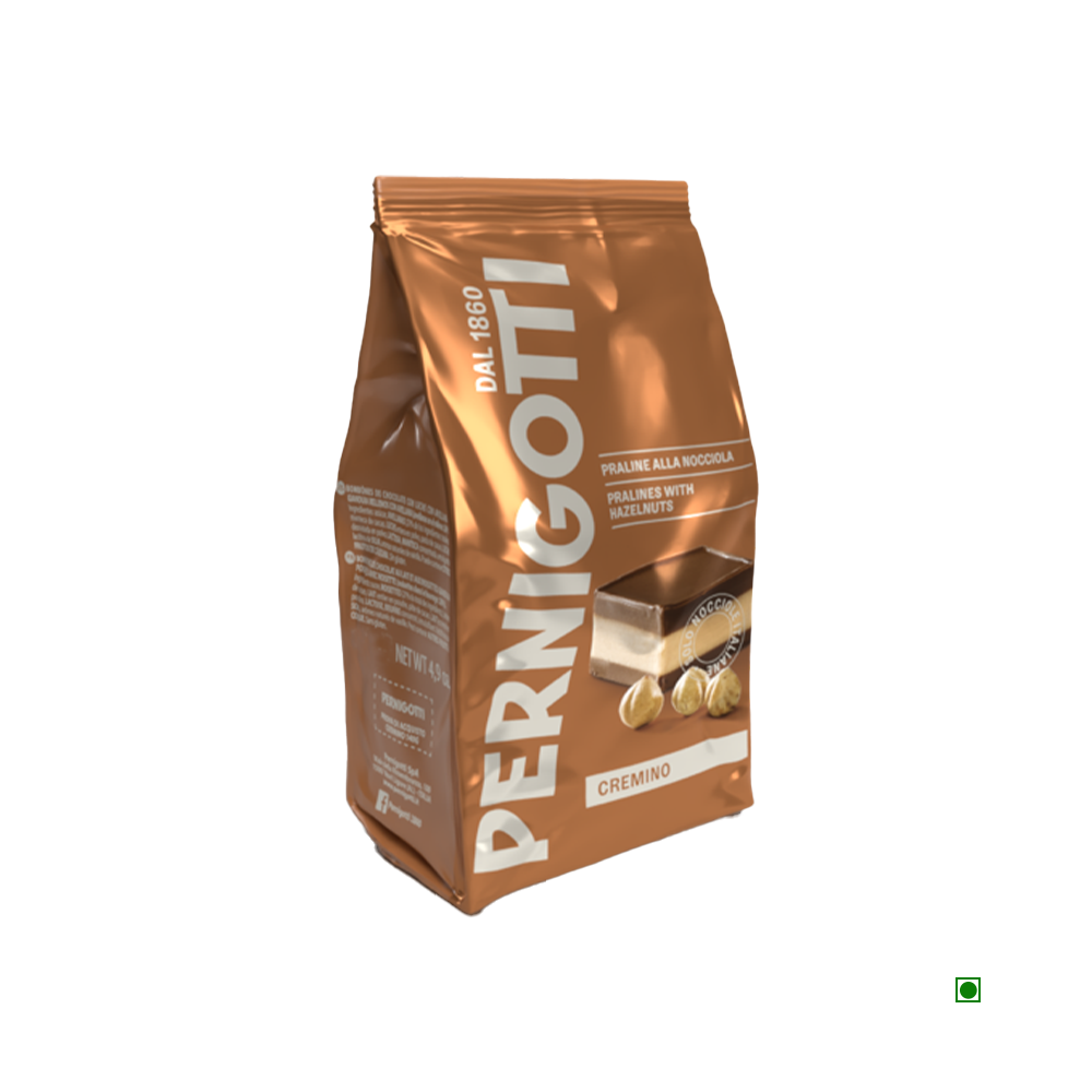 The Pernigotti Cremini Classic Bag 140g features a brown design adorned with images of hazelnuts and chocolate, inviting you to enjoy the delicious milk gianduia chocolate and its sumptuous hazelnut layer inside.