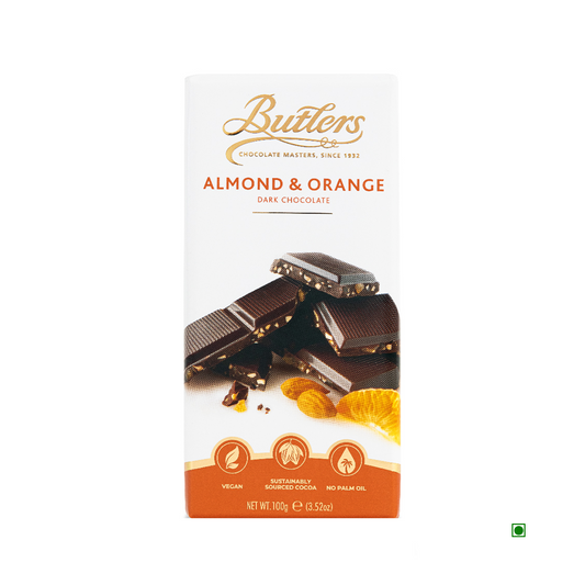 A Butlers Dark Almond and Orange Bar 100g with pieces of chocolate and orange slices pictured on the packaging. The 100g, vegan bar is made from sustainably sourced ingredients, contains no palm oil, and boasts a rich dark chocolate flavor that earned it a Great Taste Award.