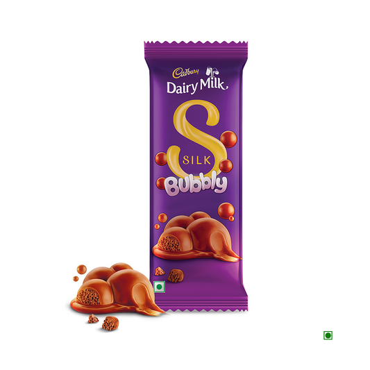 A Cadbury Dairy Milk Silk Bubbly Chocolate Bar 120g, with several pieces snapped off to display its creamy milk chocolate texture and caramel filling. Made using sustainably sourced cocoa, the packaging features a purple design accented with yellow and pink.