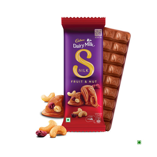 An open wrapper reveals smooth milk chocolate squares of a 137g Cadbury Dairy Milk Silk Fruit & Nut Chocolate Bar, adorned with scattered almonds and raisins.